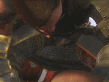 a man with a sword is holding another man 's arm with blood on it