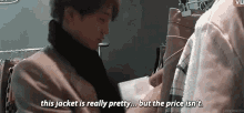a man is talking to another man in a clothing store .