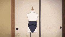 a mannequin wearing a blue swimsuit is standing in front of a sliding door
