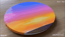 a painting of a sunset is being painted by wow art