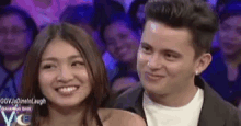 a man and a woman are looking at each other in a crowd .