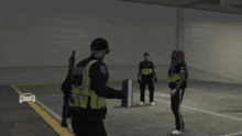 a police officer standing next to a man laying on the ground in a parking lot
