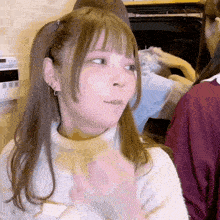 a girl with pigtails and earrings is making a funny face