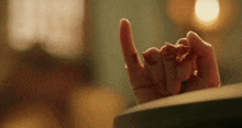 a close up of a person 's hand with blood on it making a devil horns sign .