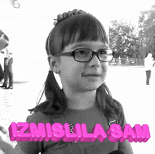 a black and white photo of a little girl with glasses and the words izmislila sam behind her