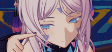 a close up of a girl 's face with a finger pointing to it