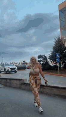 a woman walking down a street with a sign that says a on it