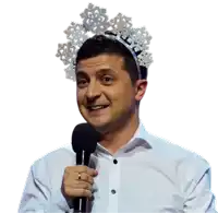 a man wearing a headband with snowflakes is holding a microphone