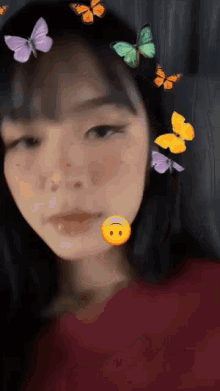 a close up of a woman 's face with butterflies on it