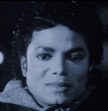 a black and white photo of a man 's face with a serious look on his face