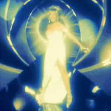 a woman in a white dress is standing in a tunnel