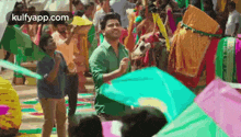 a man is flying a kite in a crowd of people .