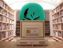 a green egg with a face on it is sitting on a desk in a library