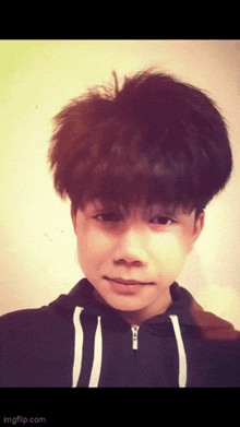 a young boy with a hoodie on looks at the camera with imgflip.com at the bottom of the image