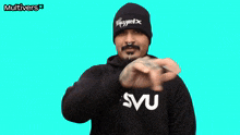 a man wearing a beanie and a sweatshirt with the word smu on it