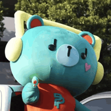 a stuffed teddy bear wearing headphones and a shirt that says ' td ' on it