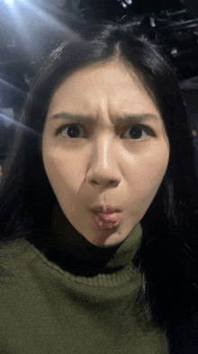 a woman is making a funny face with her mouth open