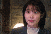 a close up of a woman 's face with her eyes wide open