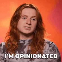 a woman with long red hair has the words i 'm opinionated on her face
