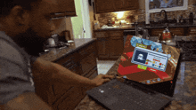 a man is playing a game on a laptop with a screen that says ' snoopy '