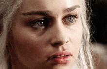 a close up of a woman 's face with blue eyes