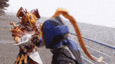 a person in a costume is fighting another person in a costume on a sidewalk .