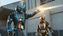 a man in a blue and black superhero costume is holding a gun