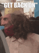 a man wearing a king 's crown and a red bandana says " get back on "