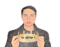 a man in a black jacket holds a gold crown in front of his face