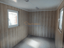 a room with wood paneling and a sign that says " бытовки врабани " on it