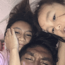 a man and two little girls are posing for a photo
