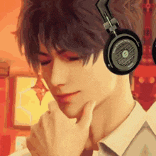 a close up of a man wearing headphones with his hand on his neck .