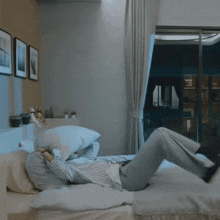 a person is laying on a bed with their feet up