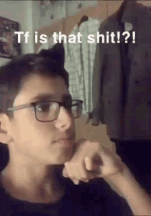 a young boy wearing glasses is making a funny face with the caption tf is that shit !