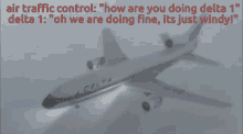 a delta airplane is flying in the air with the words " air traffic control " above it