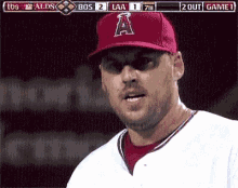 a baseball player wearing a red hat with the letter a