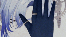 a close up of a person 's hand with rings on their fingers