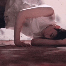 a man is laying on his stomach on the floor .