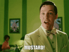 a man in a suit says mustard in a green room