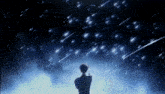 a person standing under a starry night sky with shooting stars