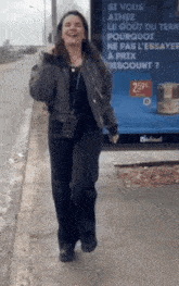 a woman is standing in front of a billboard that says 2.59