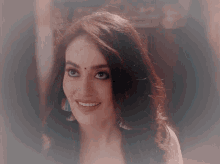 a close up of a woman 's face with a bindi on her forehead