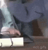 a man is sitting at a desk using a laptop computer .