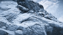 a mountain covered in snow and rocks with the word legends on the bottom left