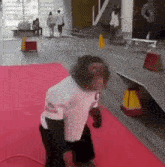 a monkey is standing on a red carpet in front of a building .