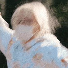 a blurry picture of a person 's face with their arms outstretched .