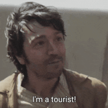a man says i 'm a tourist in a close up of his face