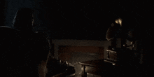 a man sits in a chair in a dark room