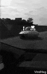 a black and white photo of a cartoon character in a flying saucer