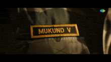 a patch on a person 's jacket that says mukund v